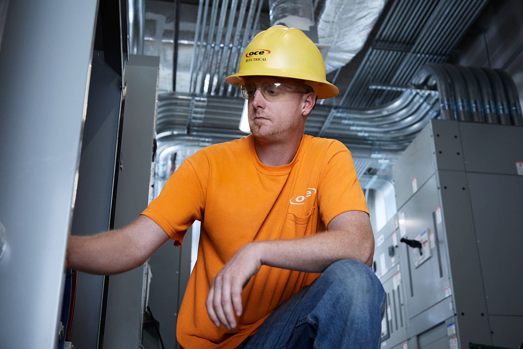 a worker reaching into an electrical box