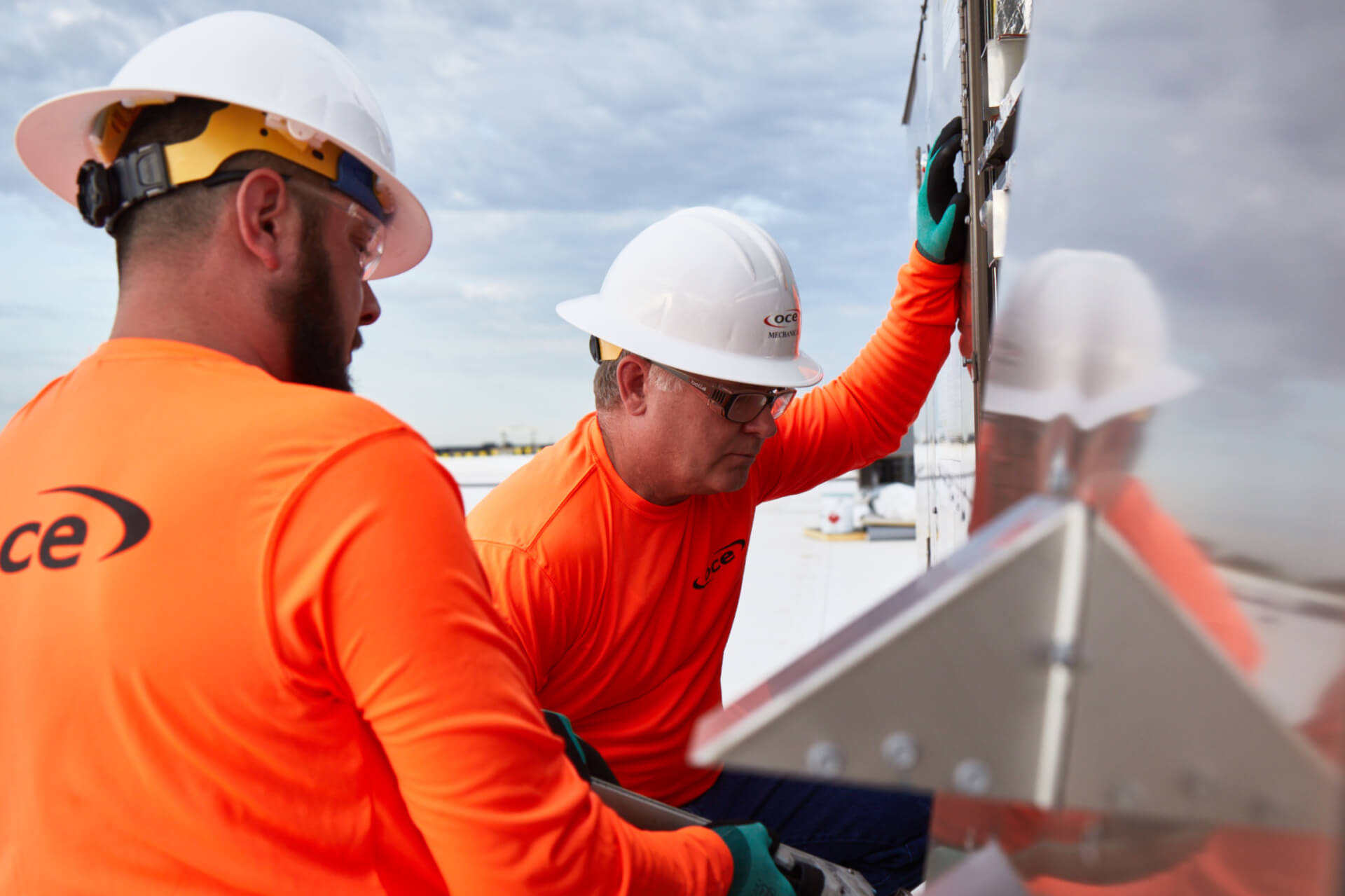 2 workers looking into an electrical box